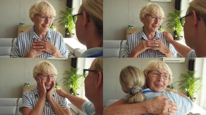 护士在家访时拥抱老年妇女