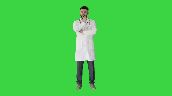 医生站在绿色屏幕上努力思考