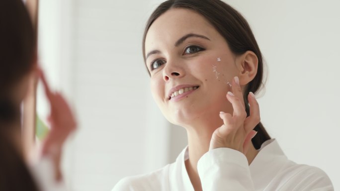 涂抹保湿霜的女人妇女护肤品化妆品面霜脸霜