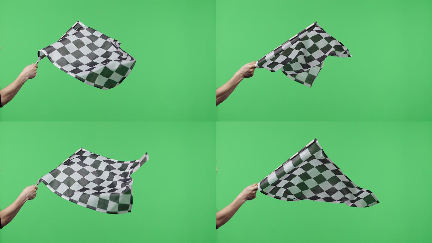 在绿色屏幕背景下，手持并缓慢挥舞方格旗。