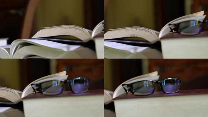 打开和合上的书，还有桌子上的眼镜。