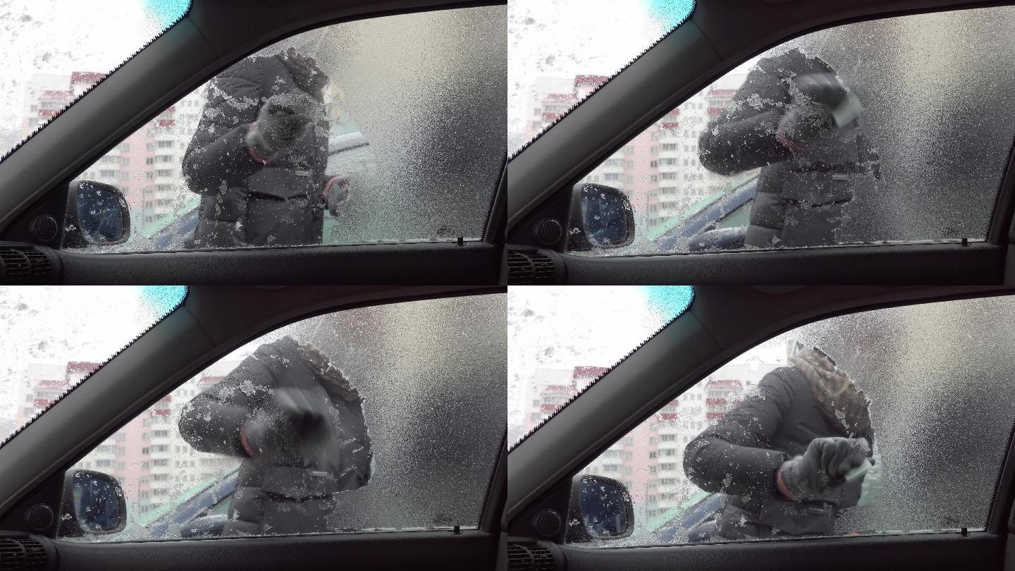 刮去汽车挡风玻璃上的冰。