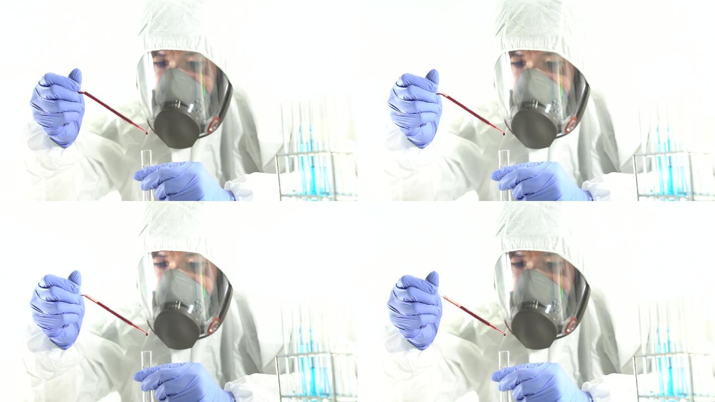 科学家将血液滴入科学实验室的玻璃管中