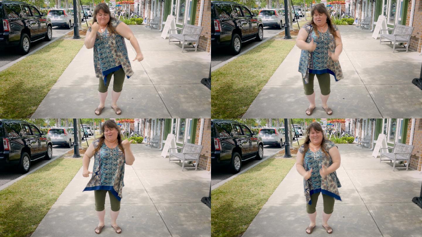 胖女人在城市人行道上跳舞