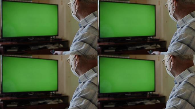 老人在绿色屏幕上看电视