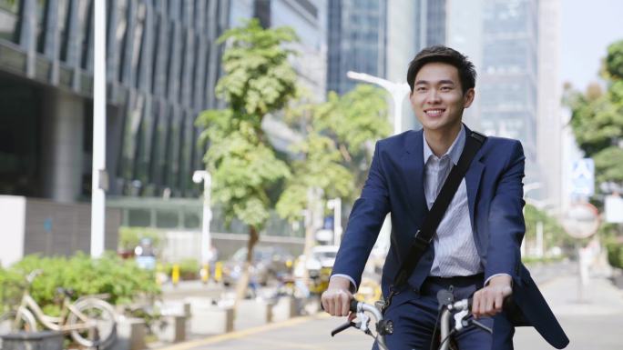 年轻的亚洲商人骑自行车上班
