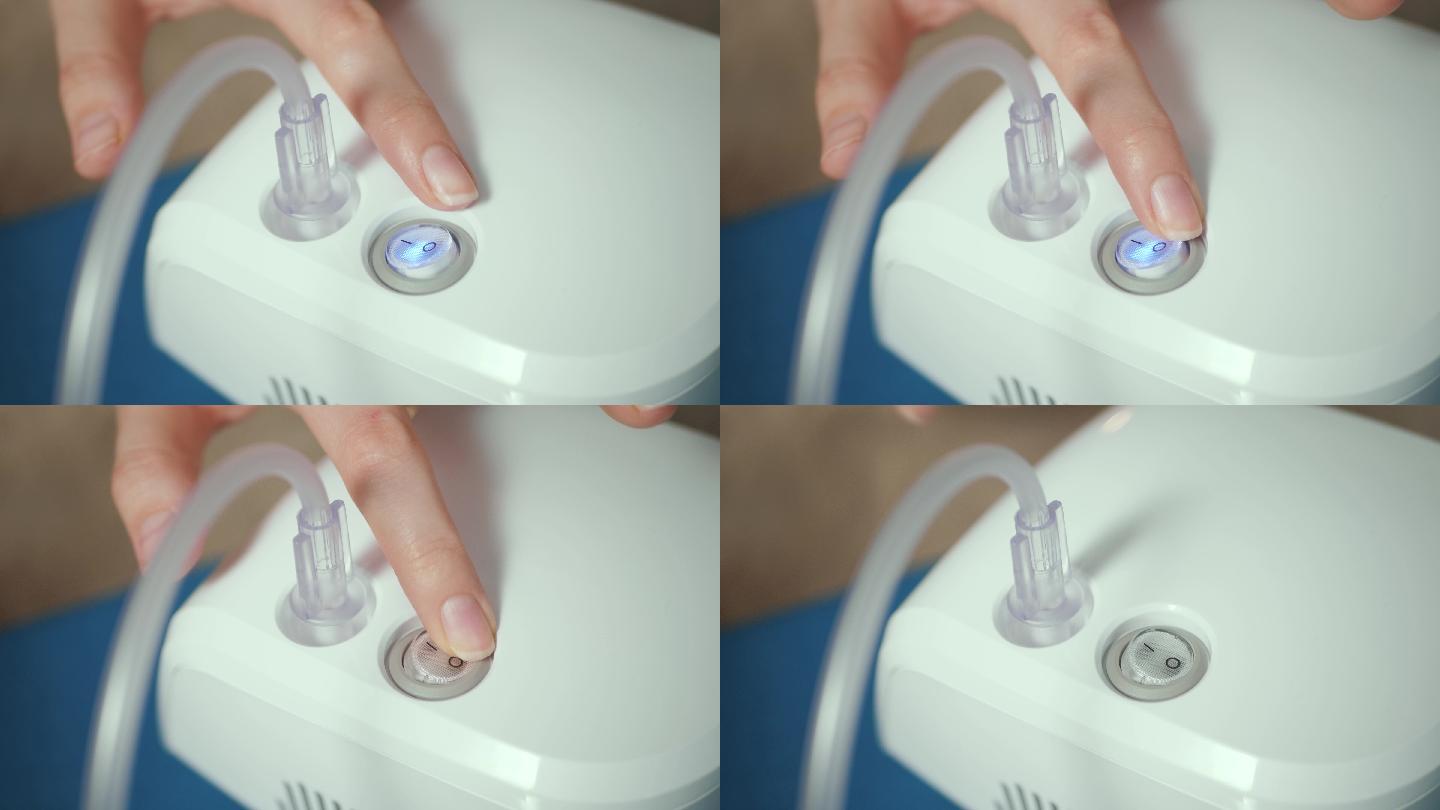 女性按下雾化器上的关闭按钮进行吸入。