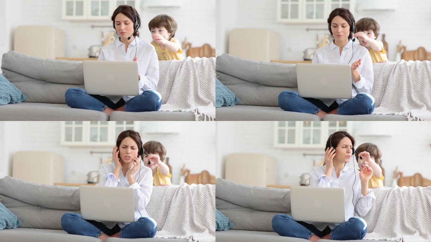 母亲坐在家里用电脑工作，孩子一直打扰母亲