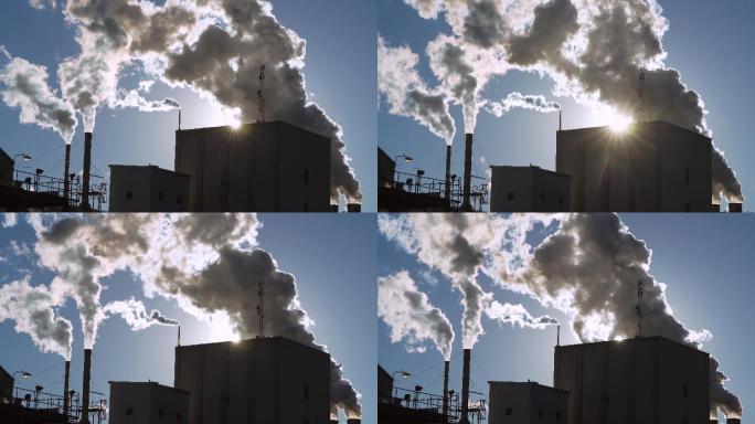 太阳光照射下工厂里滚滚的烟雾和蒸汽