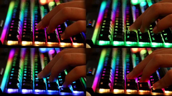 游戏玩家按下彩色LED背光键盘