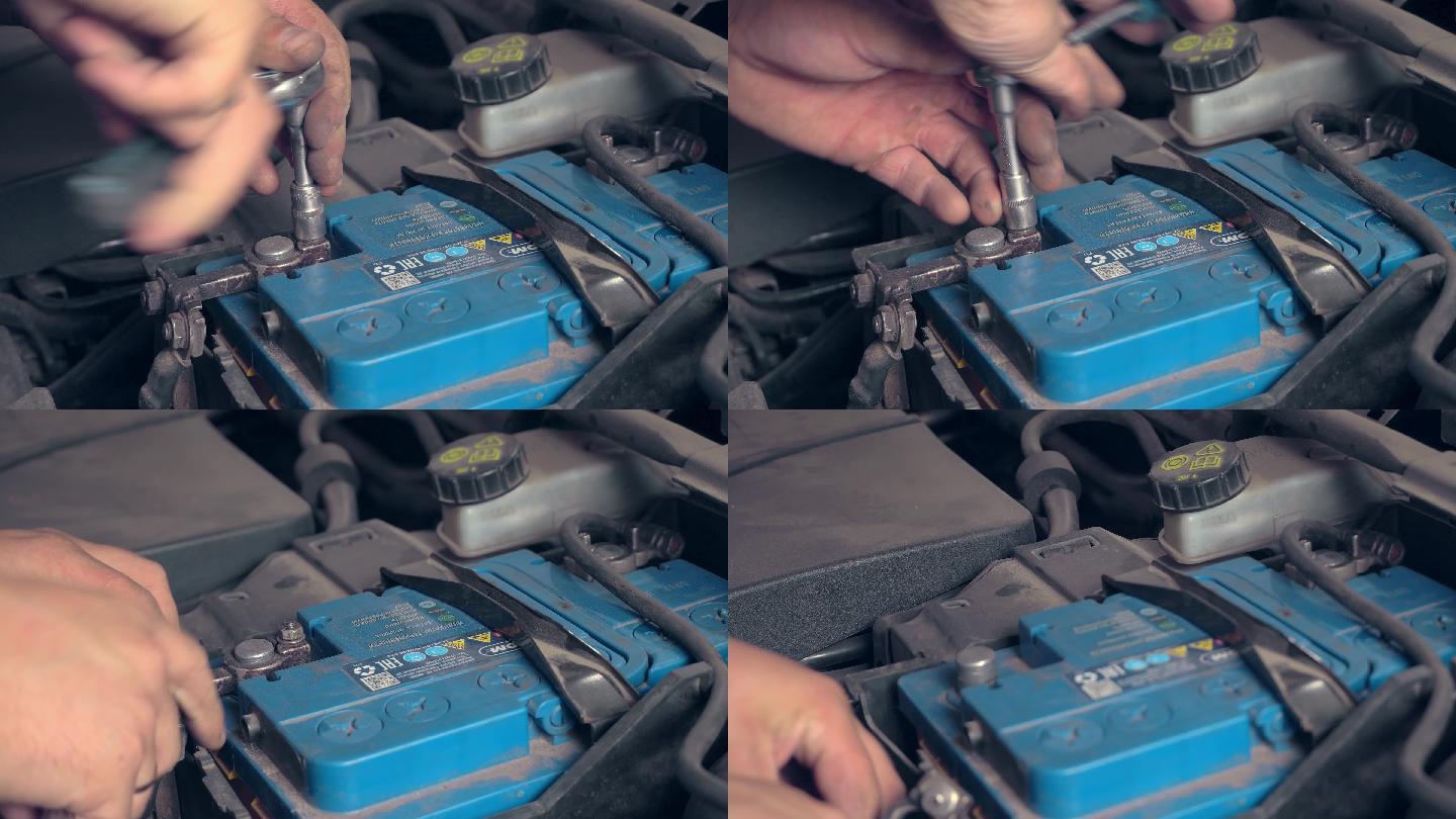 机械师从电池上断开端子的特写镜头。