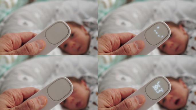 母亲用数字非接触温度计测量婴儿体温。