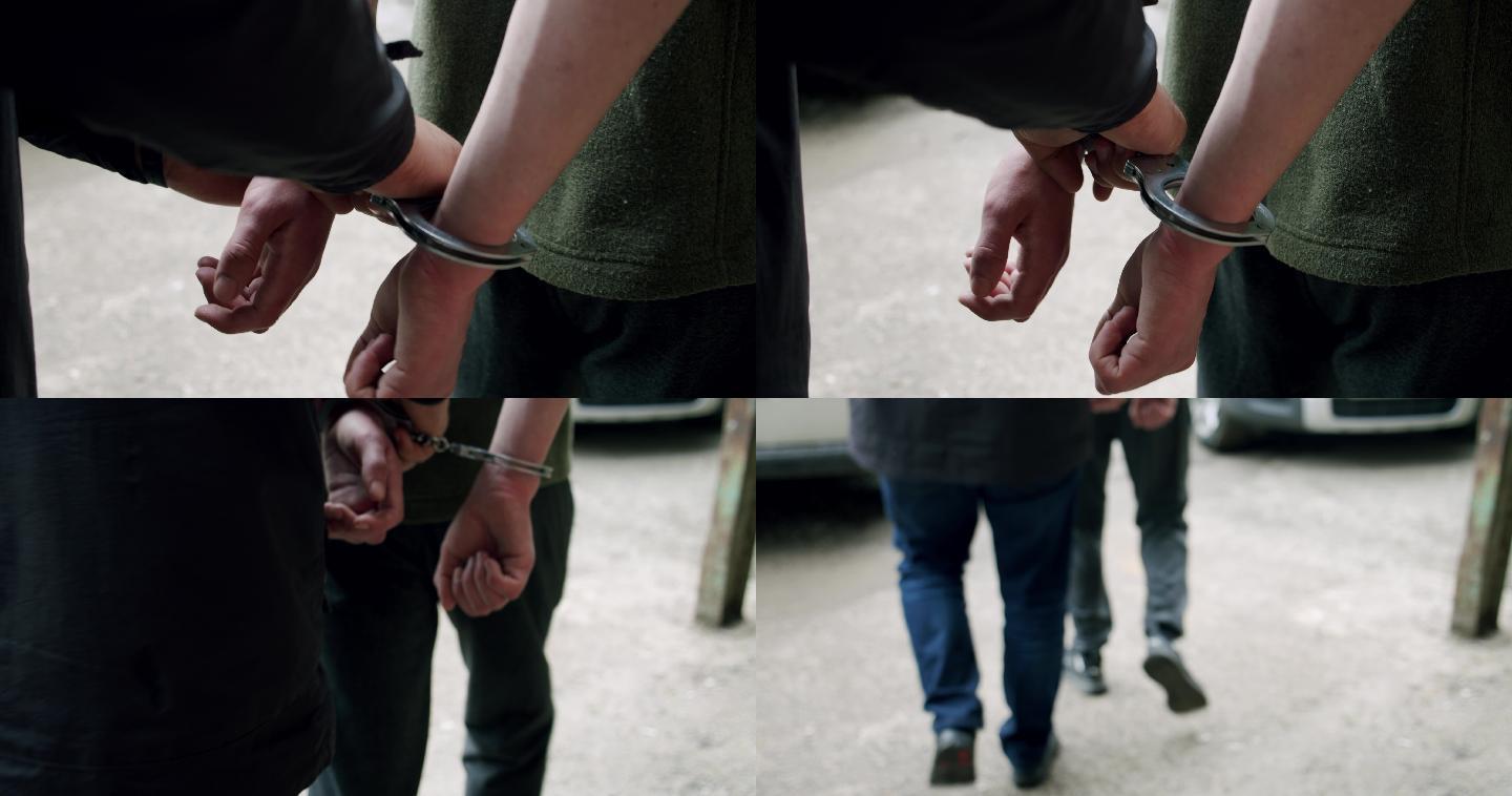罪犯戴上手铐被带到警察局。