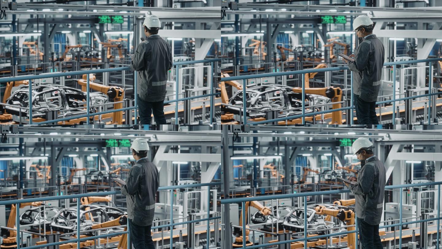 汽车工厂工程师穿着工作服使用平板电脑。