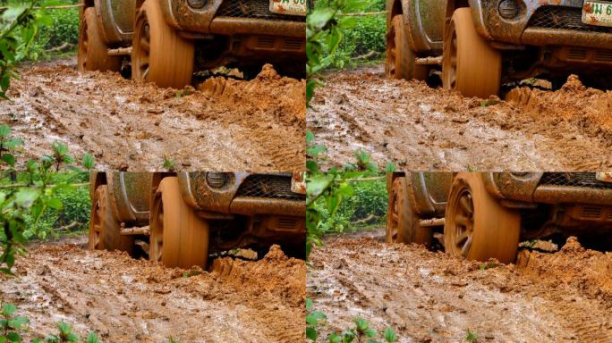 四轮驱动的皮卡车陷在泥里，试图走出泥潭。