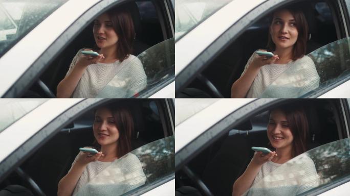 女人坐在车内使用智能手机语音识别功能