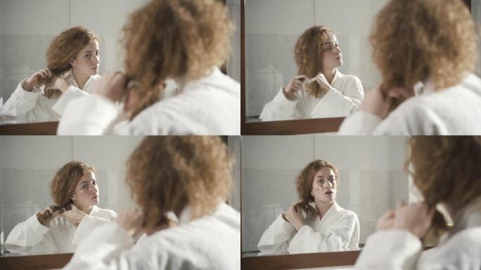 穿着白色浴袍的女士在浴室镜子里