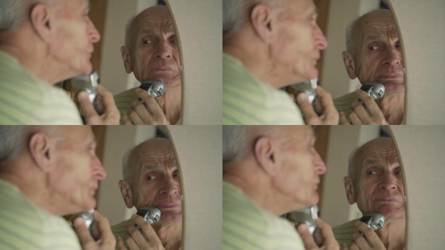 严肃的老人照镜子刮胡子