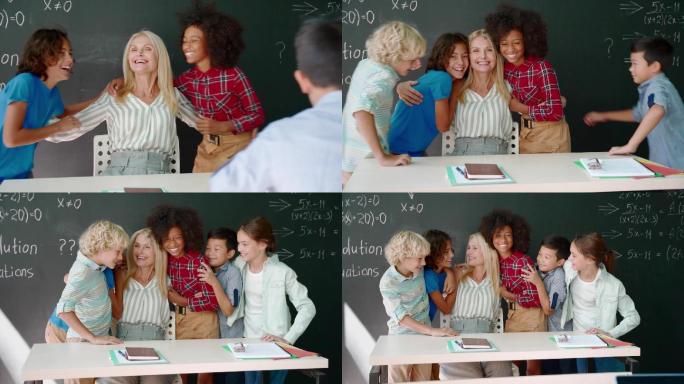 快乐的老师和快乐的学生们在教室的黑板旁。