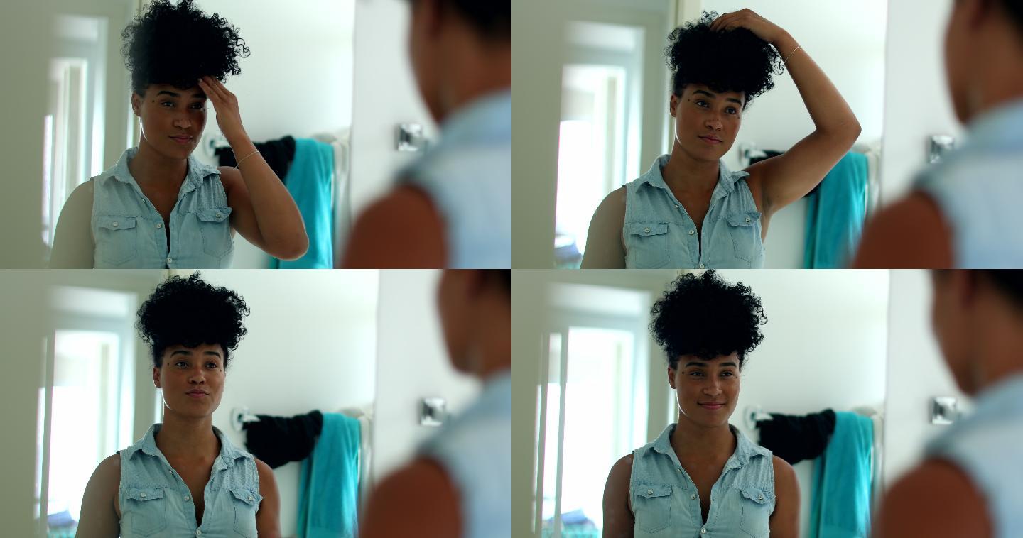 女子在浴室镜子前整理头发