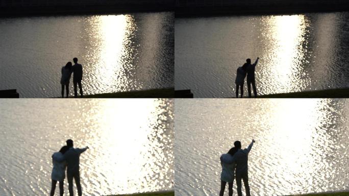 情侣在湖边看夕阳