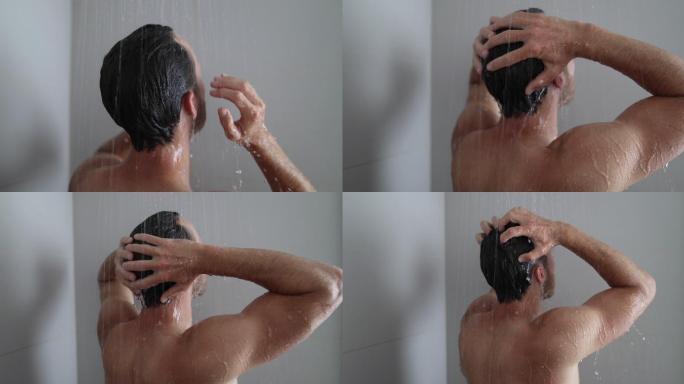 男人在家里的浴室里洗头发