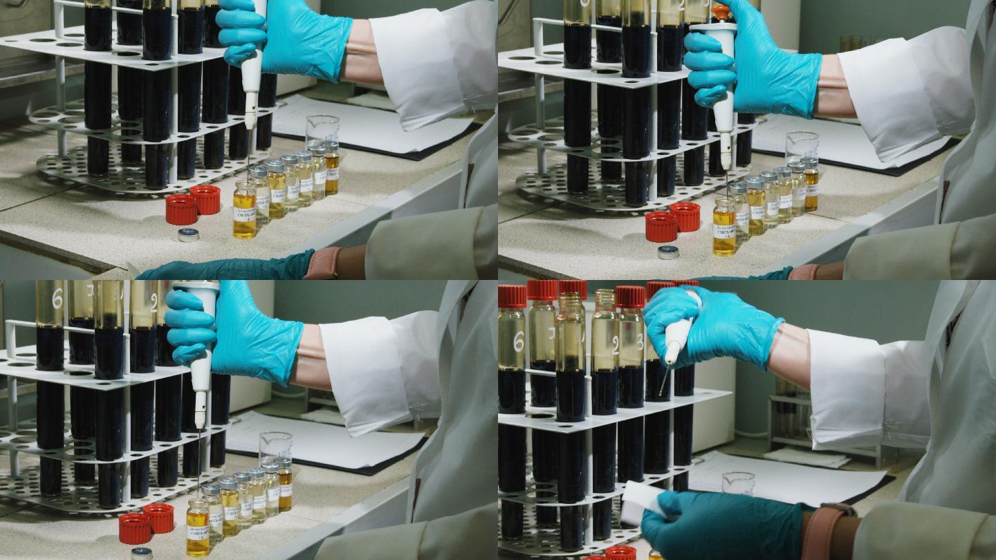 实验室助理用器具取少量黄色液体