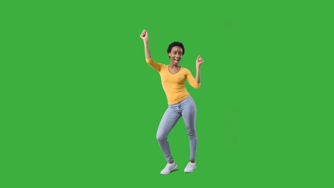 在绿色背景上跳舞的快乐女人