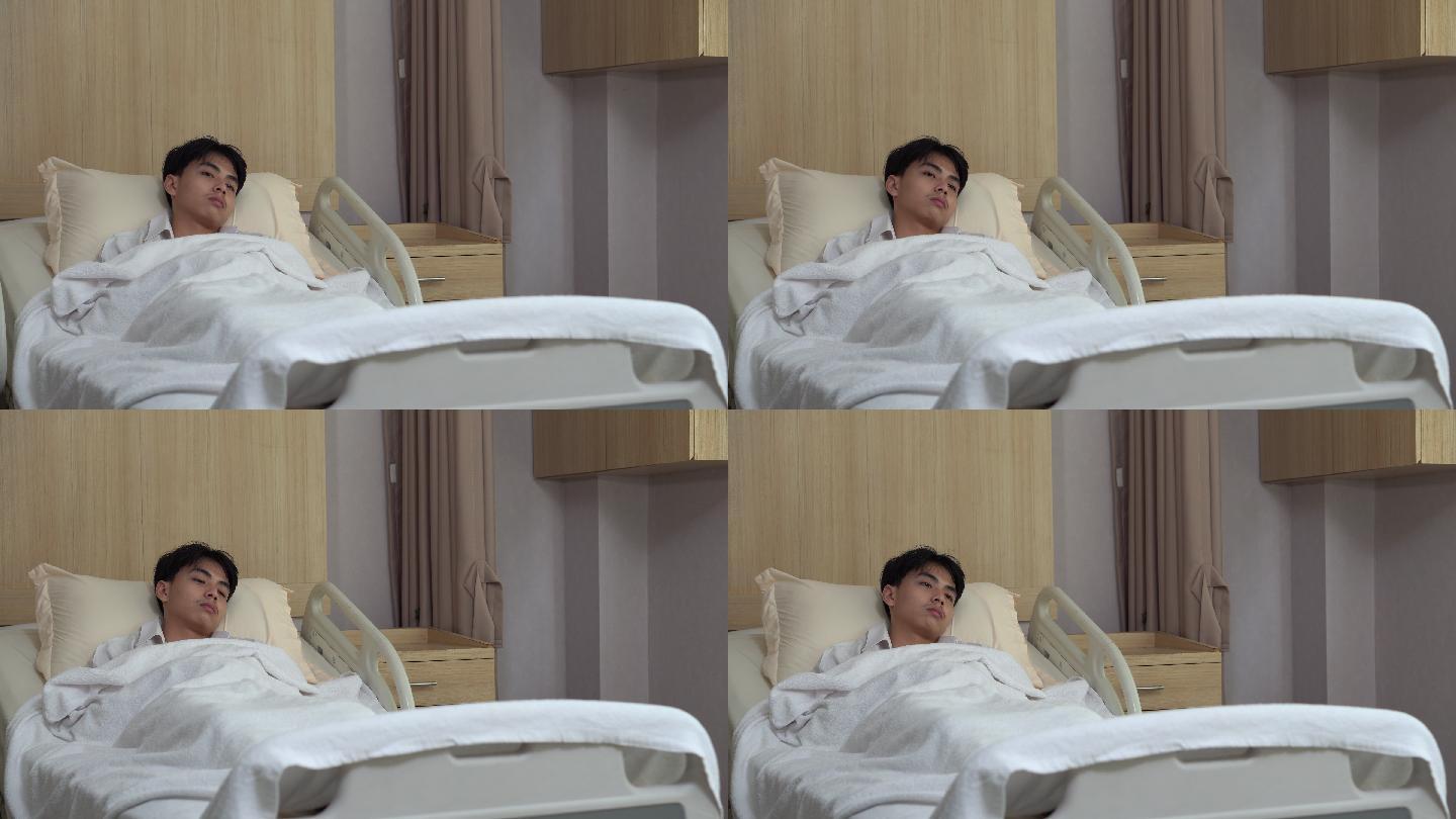 年轻男子躺在床上看着医院