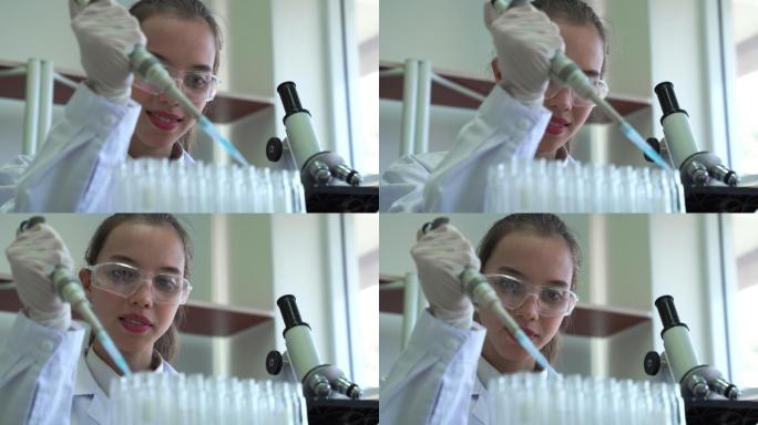 女科学家使用移液管滴管样本来测试试管