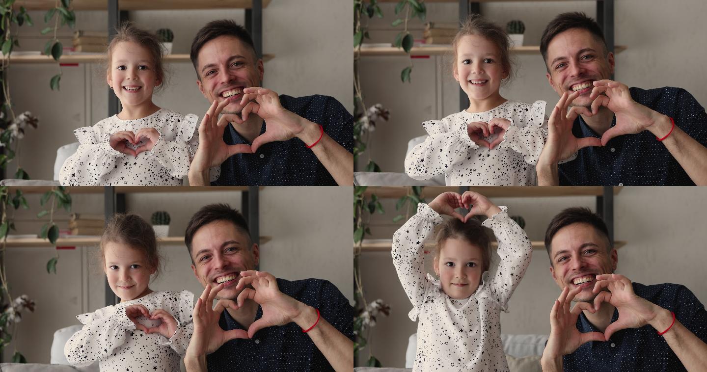 爸爸和小女儿用手指做心形