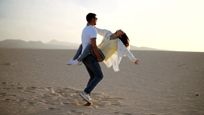 年轻夫妇在空旷的沙漠中大笑