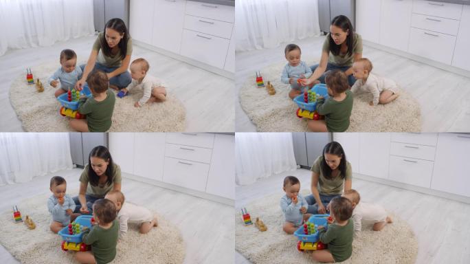 三胞胎妈妈和幼儿坐在一起玩玩具
