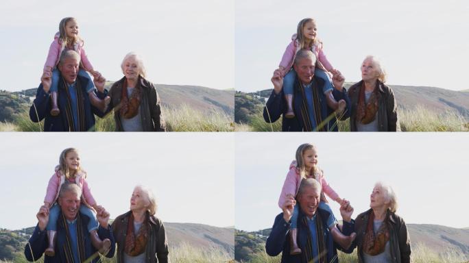 祖父肩上扛着孙女，和祖母一起散步