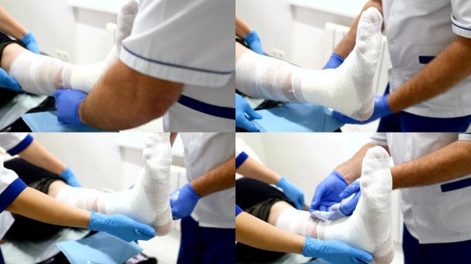 创伤科医生在病人的断腿上贴了一块膏药