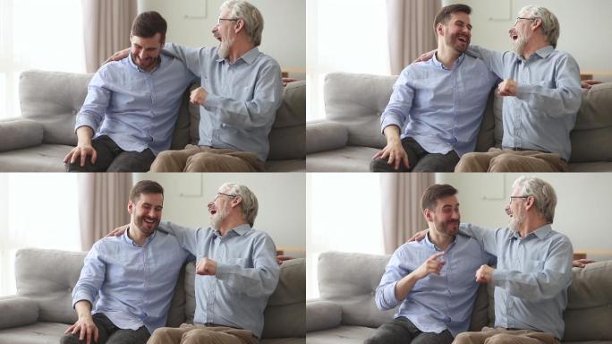 快乐的老父亲笑着拥抱着儿子