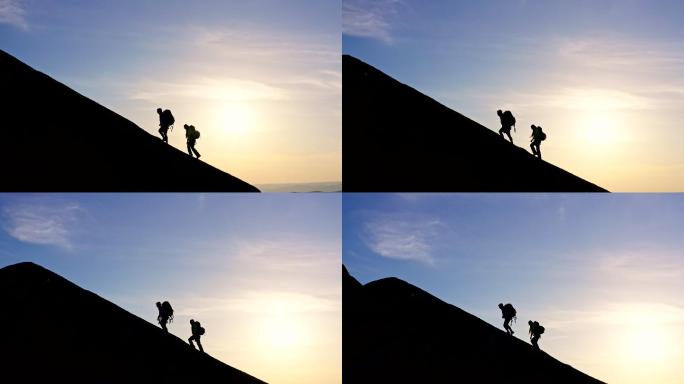 一男一女背着背包爬上山顶的剪影