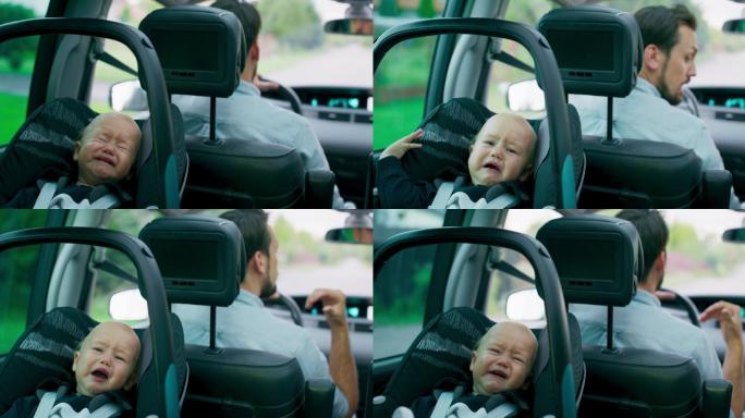 哭泣的男婴坐在车内后排座椅上