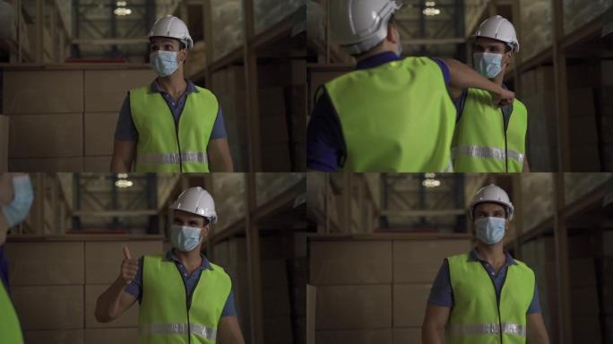 男性工厂仓库工人戴口罩在物流行业室内工作
