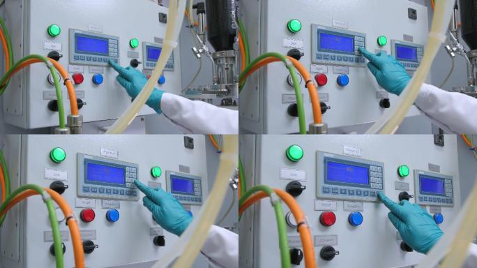 实验室里女人按下机器控制面板上的按键