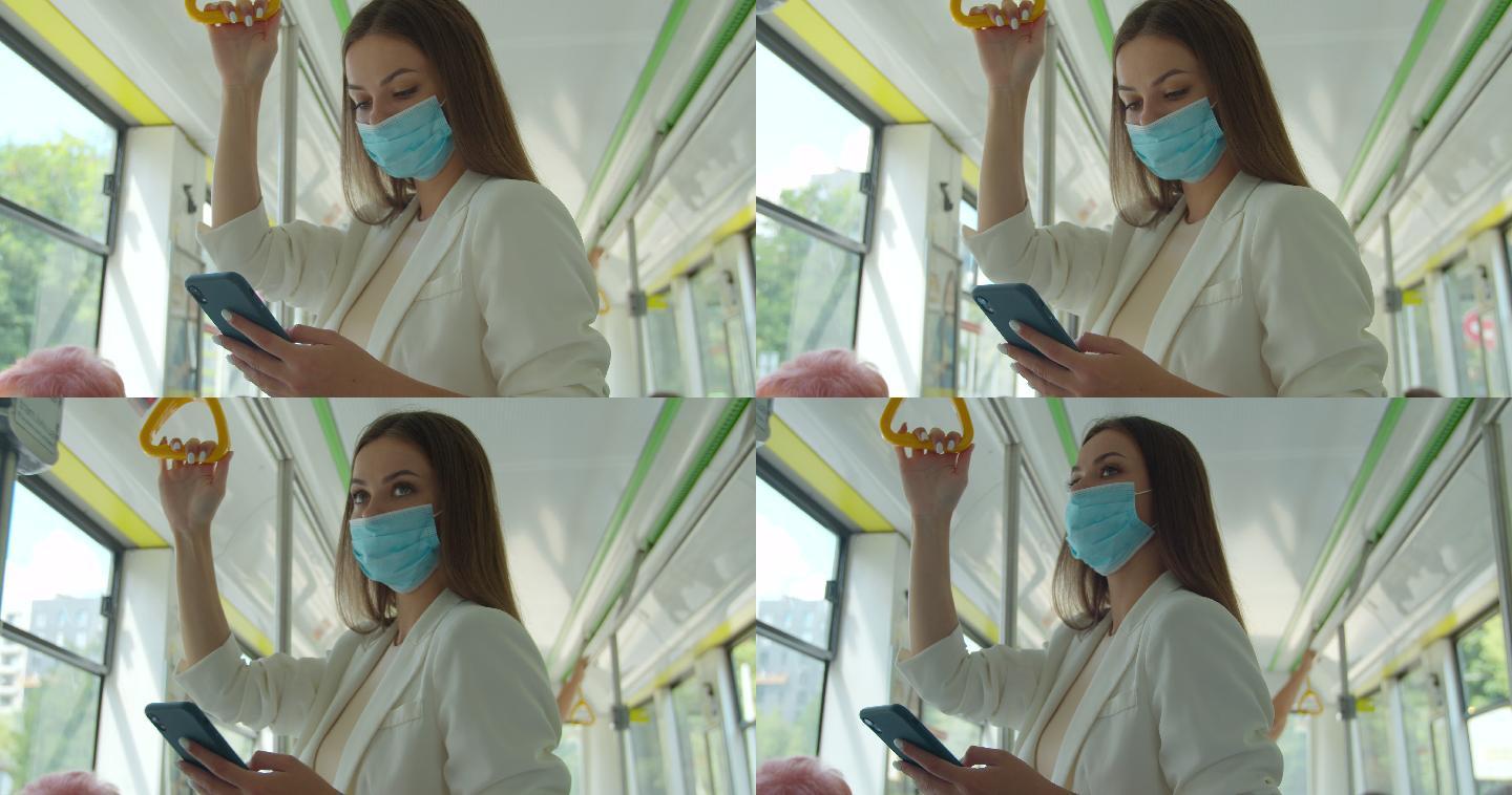 一名戴着口罩的年轻女子乘坐公交车