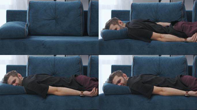 躺在沙发上的男子疲惫疲劳劳累下班回家国外