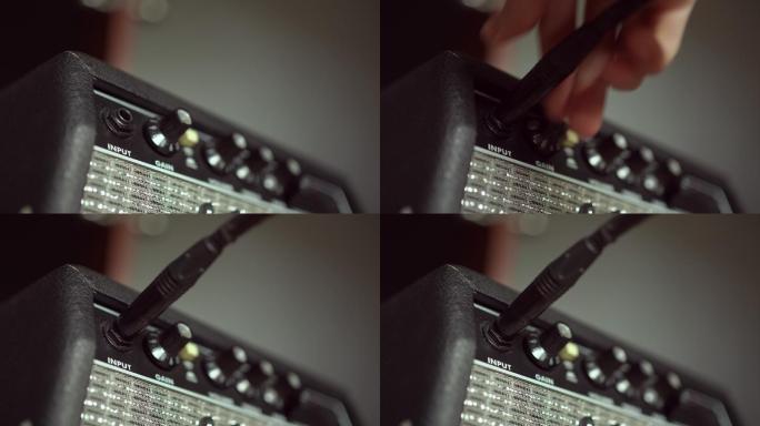 将乐器电缆插入吉他放大器