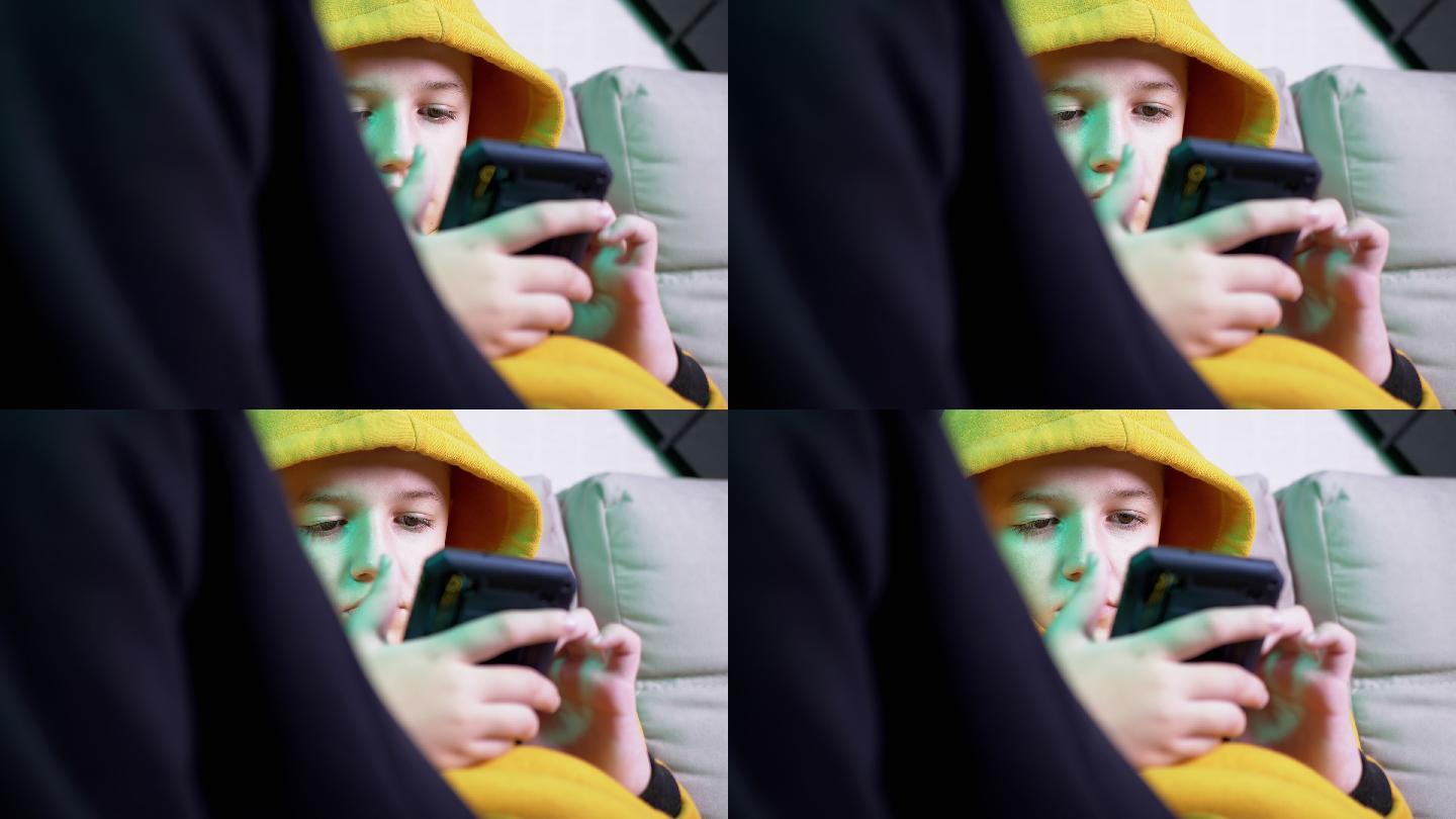 玩手机的小男孩小孩子实拍视频素材黄色衣服