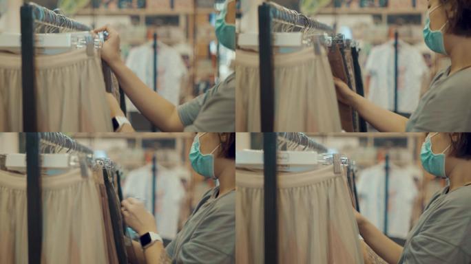 女商人带着口罩在服装店购物