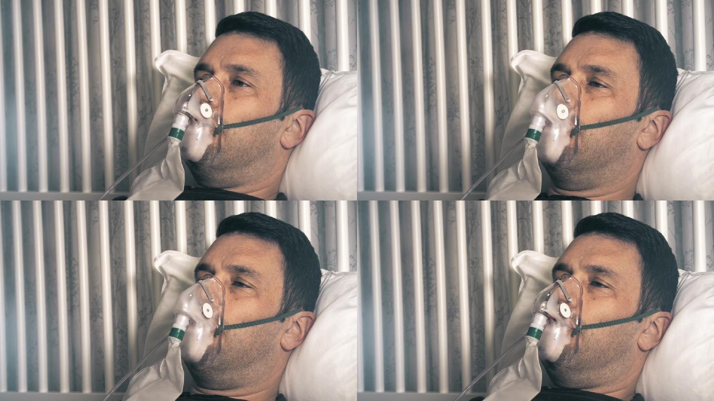 男性由于呼吸困难，他戴着氧气面罩。