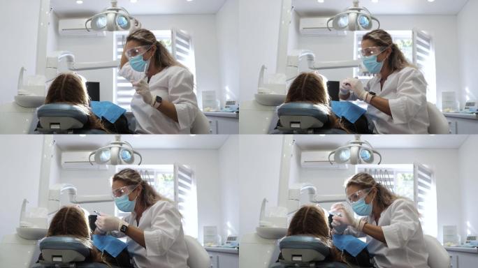 年轻女牙医正在检查女患者