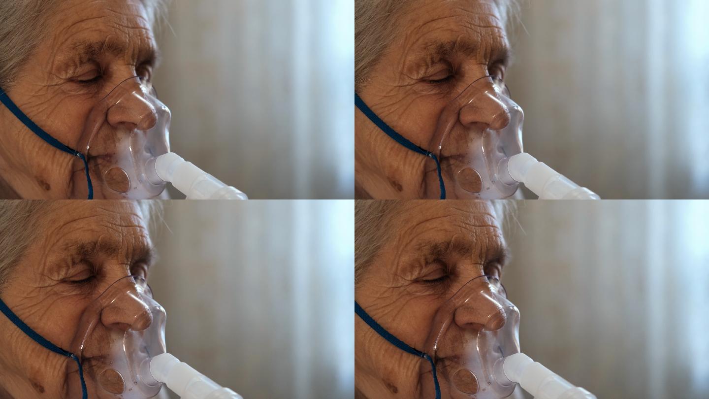 一位戴着医用呼吸面罩的闭着眼睛的老妇人
