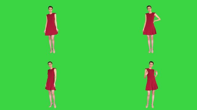 身着红色连衣裙的女孩在绿色屏幕上