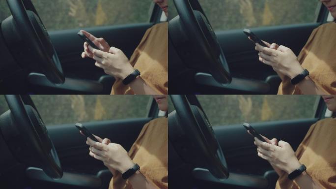 年轻女子在车内使用手机